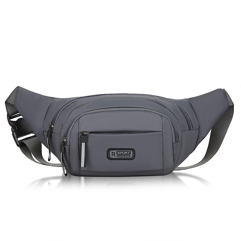 Compact sling pack in gray with matte texture and dual zippers.