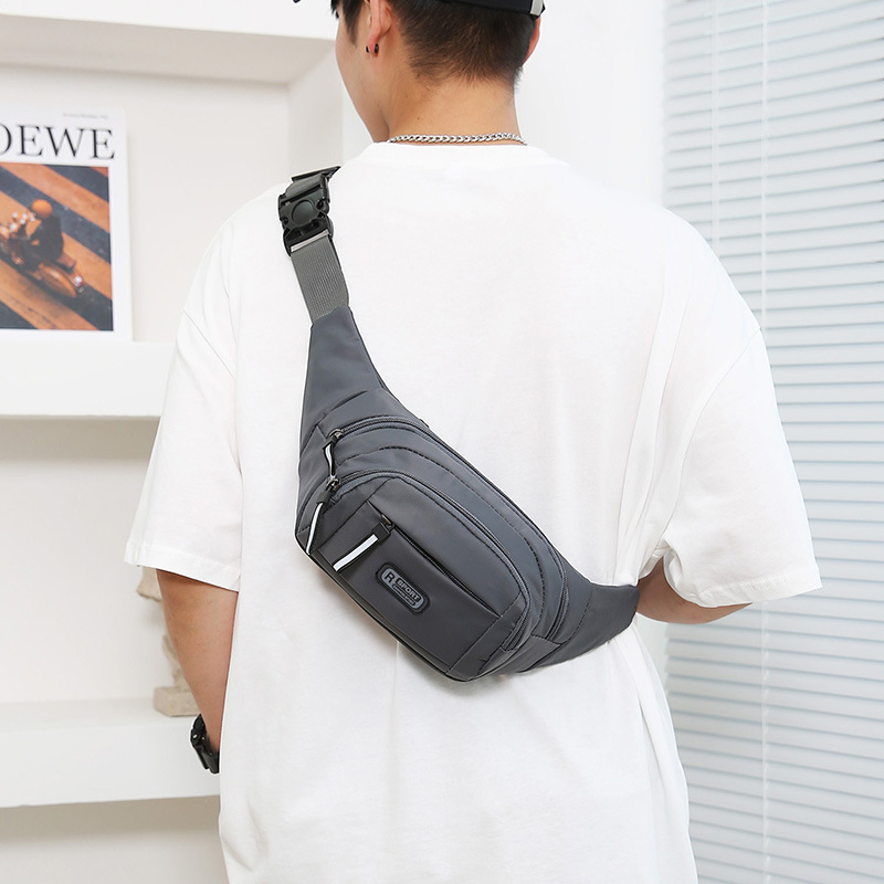 Model wearing compact sling pack across back indoors showing casual fit.