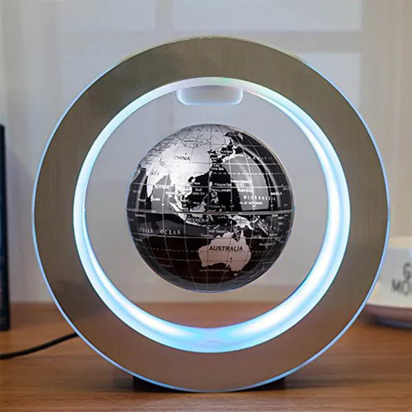 Floating globe with a black world map design levitating inside a silver circular LED frame.