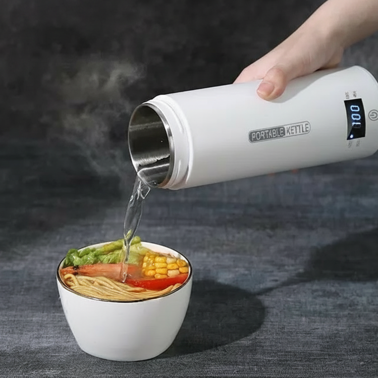 User pouring hot water from electric kettle into a bowl of noodles.