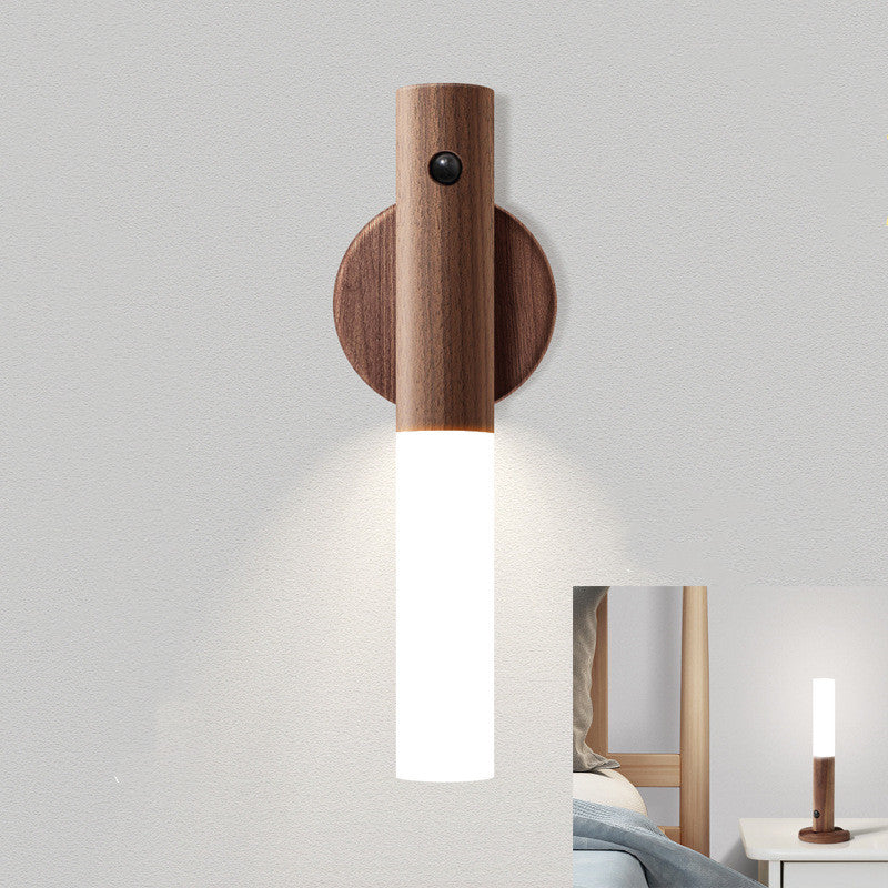 Wall-mounted LED stick light with warm wood-toned base and soft downward illumination.