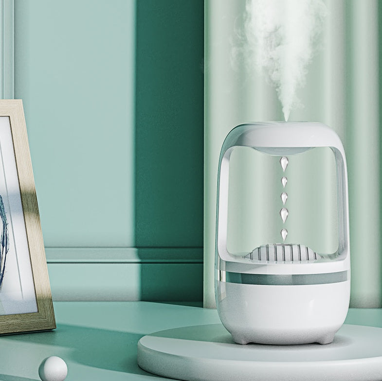 Humidifier positioned on a desk emitting cool mist in a softly lit interior setting.