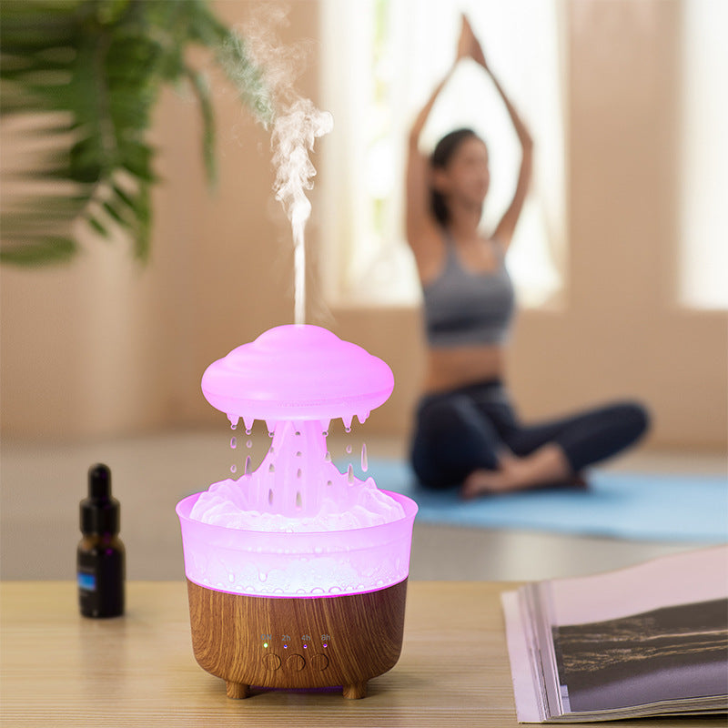Humidifier glowing softly in a living space beside yoga accessories and essential oils.