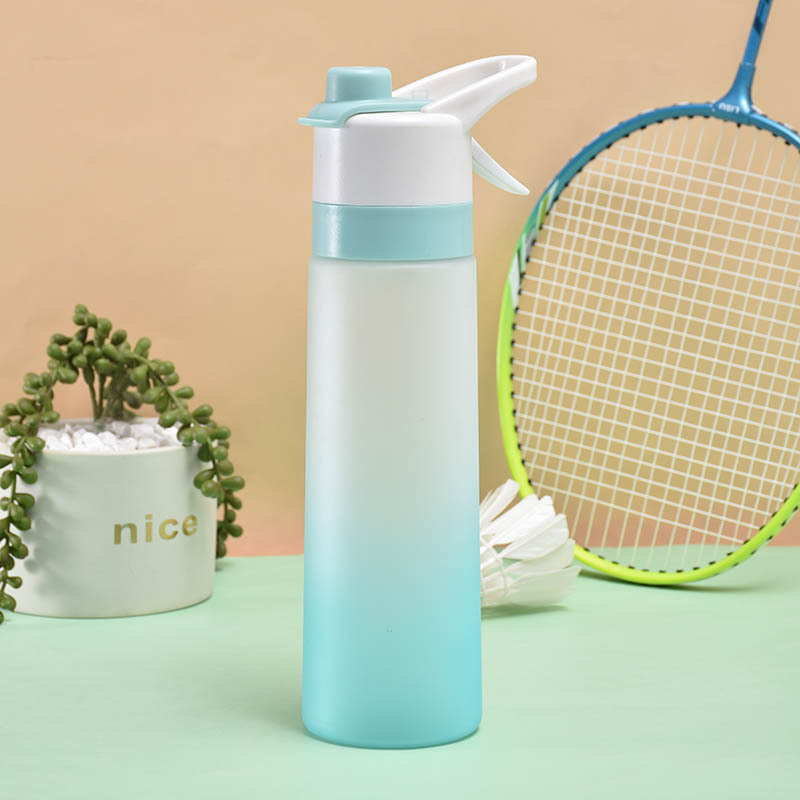 Gradient blue spray water bottle next to a tennis racket.