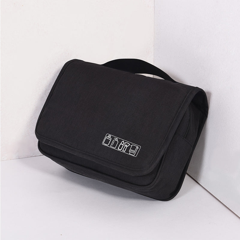 Hanging toiletry organizer in black fabric with handle and compact shape.