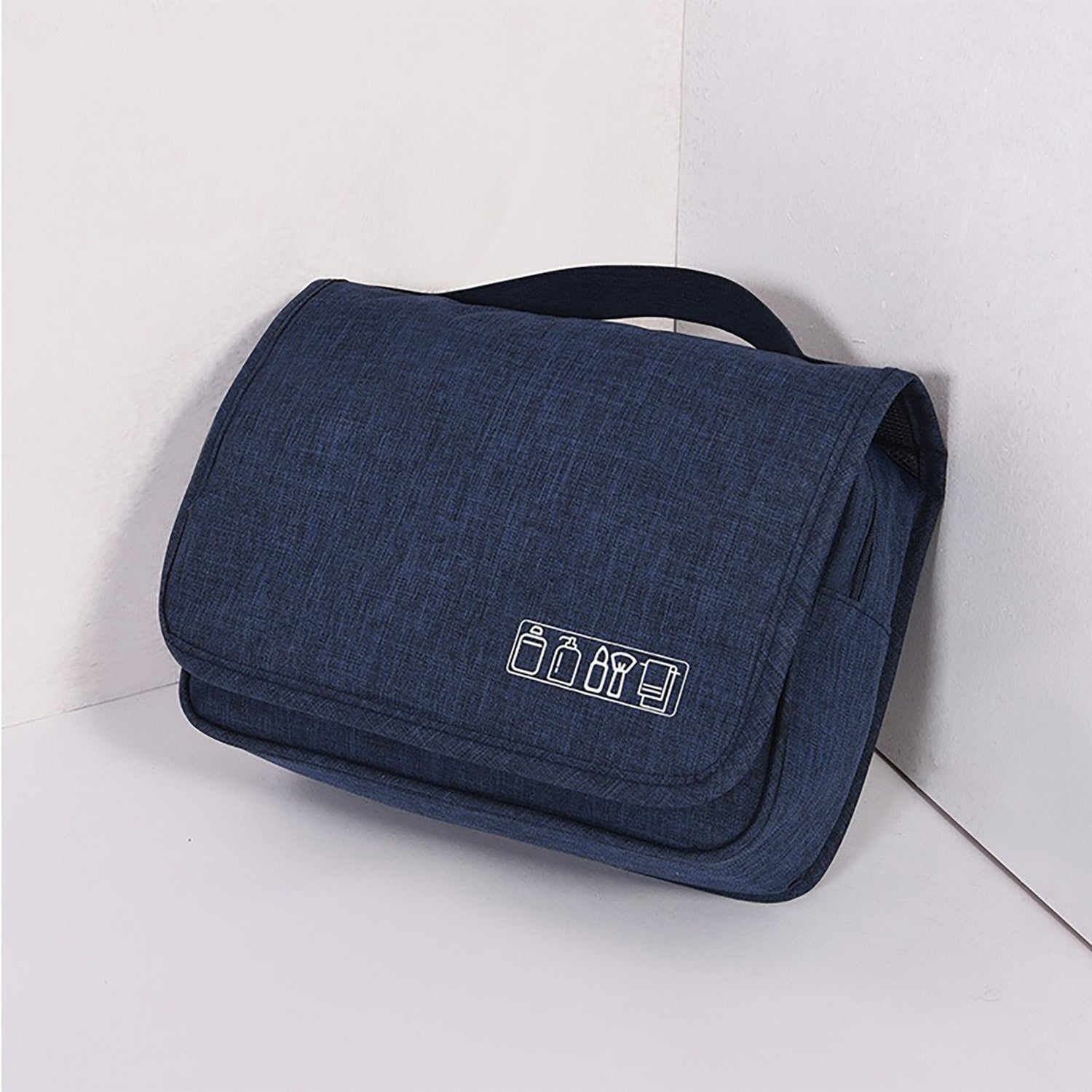Hanging toiletry organizer in dark blue with front logo and travel-ready design.