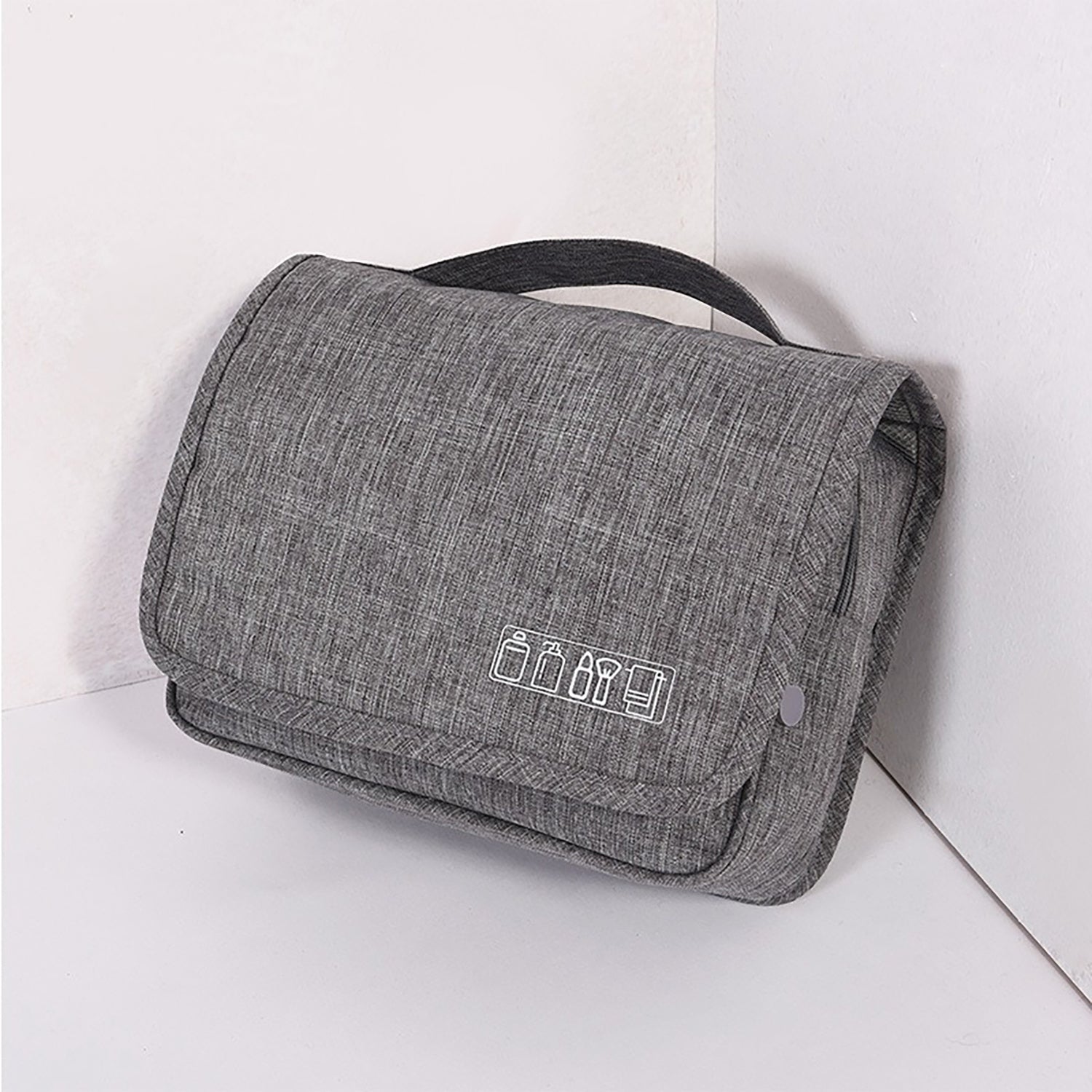 Hanging toiletry organizer in grey showing textured fabric finish.