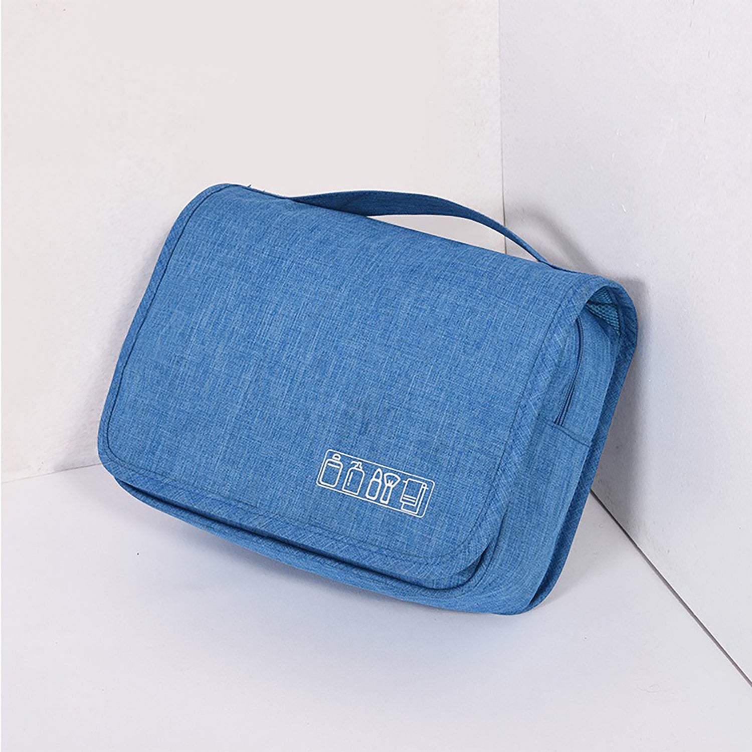 Hanging toiletry organizer in light blue with zippered compartments and handle.