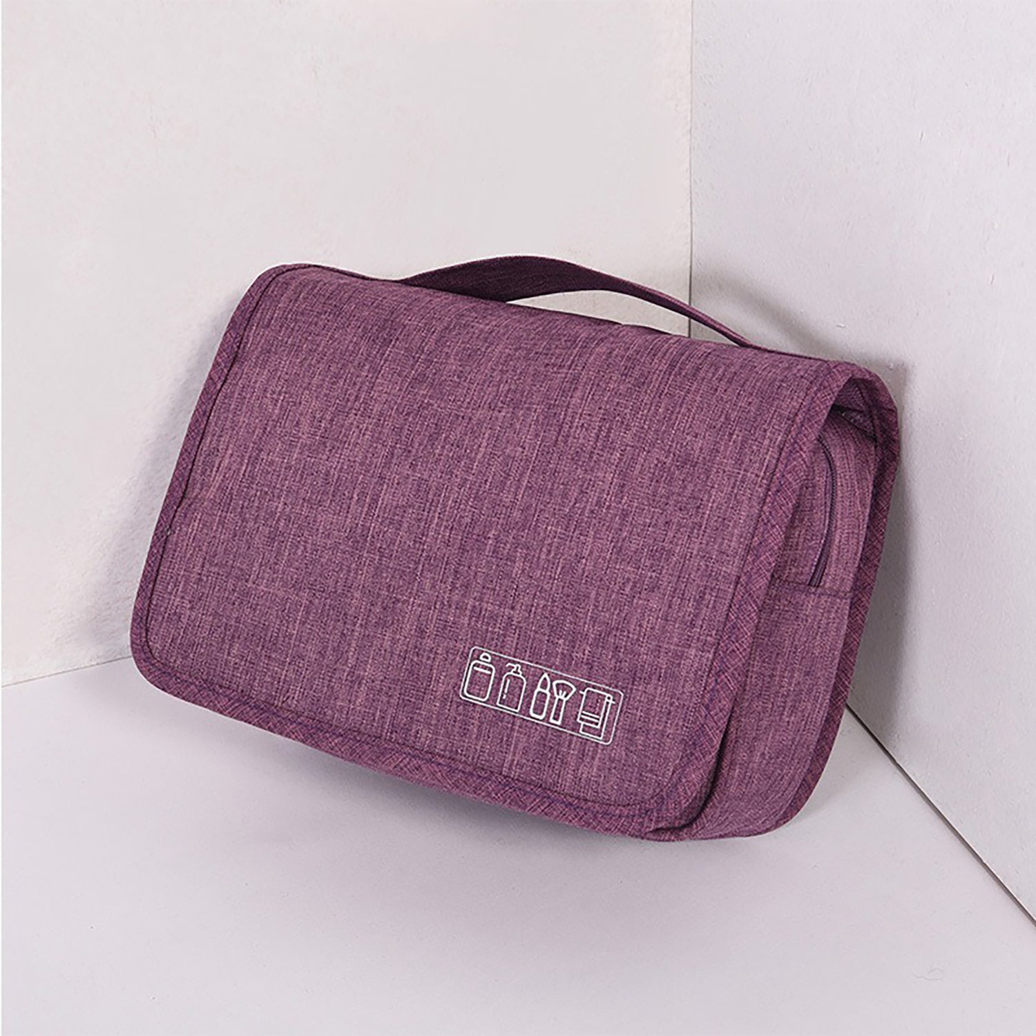 Hanging toiletry organizer in purple with soft fabric exterior and logo icons.