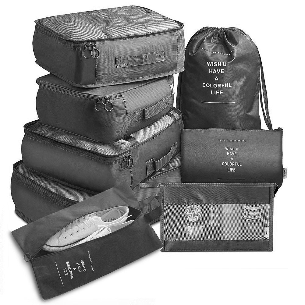 Travel organizer set in black with drawstring laundry bag and zip pouches.