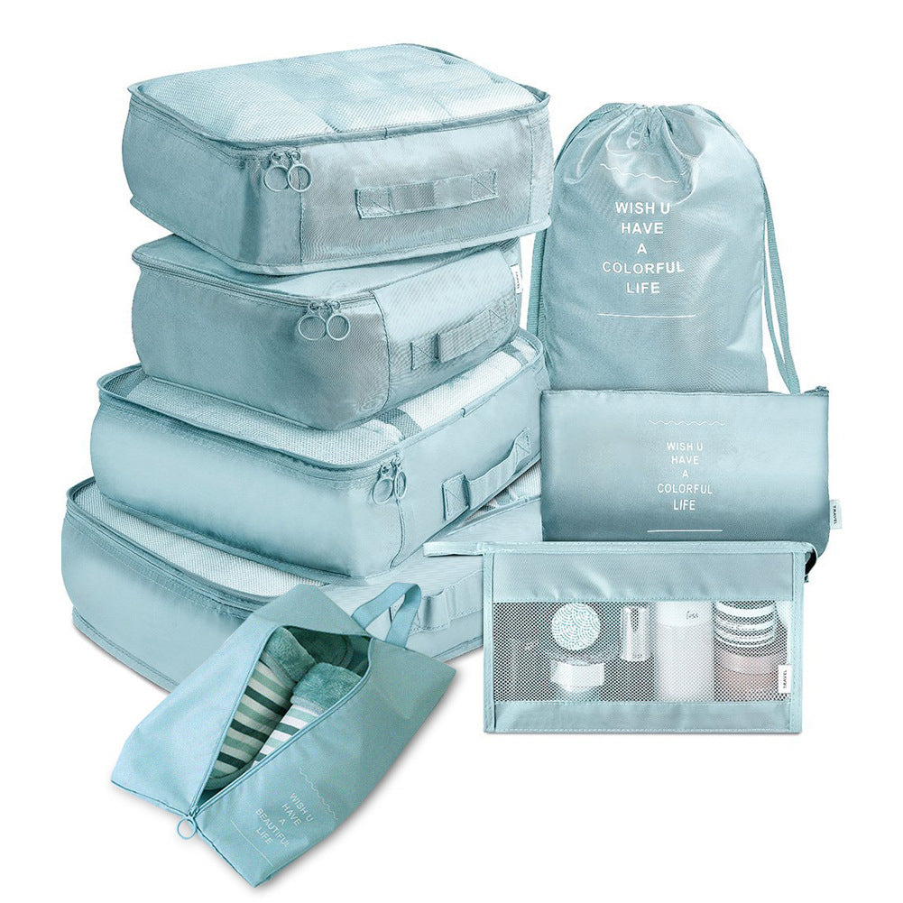 Travel organizer set in light blue with seven packing cubes and toiletry bag.