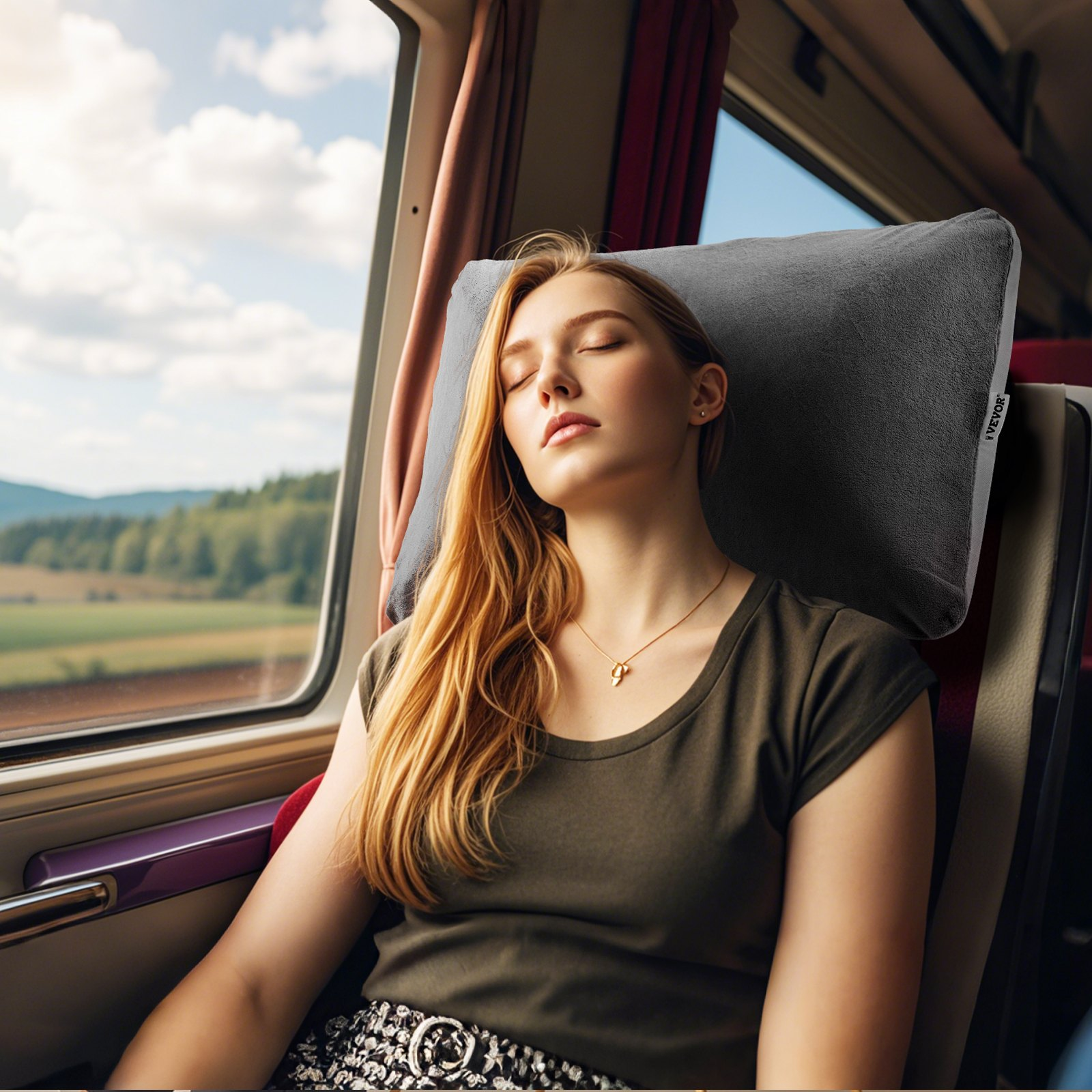 Woman relaxing on a train using the FlowRest memory foam travel pillow in grey.