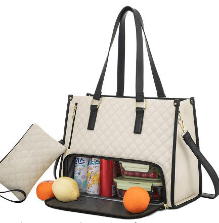 Quilted lunch and travel bag in beige with insulated lower compartment and fruit inside.
