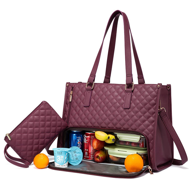 Wine-red insulated tote filled with lunch boxes, drink can, and fruit.