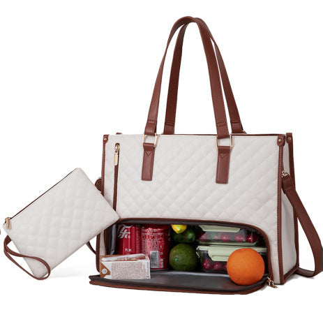 White insulated tote with dual handles and removable strap beside lunch boxes.